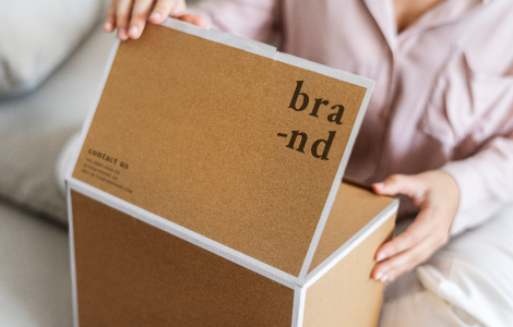 woman unpacking brown box in the living room